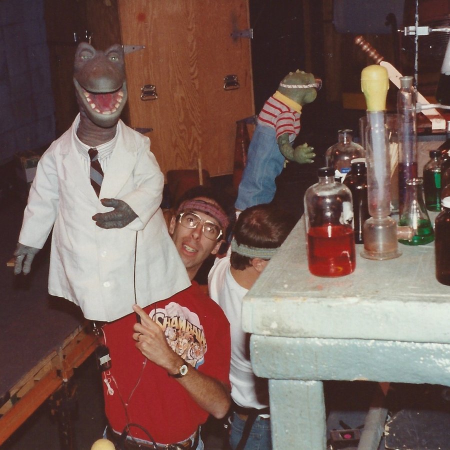 Allan performing the character Mr. Lizard on the set of Dinosaurs